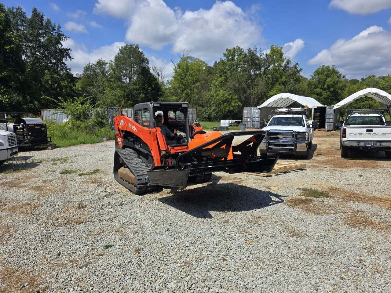 Kubota SVL97-2 with a SkidPro brush hog in Lawrenceburg knocking down brush so the lot can be used