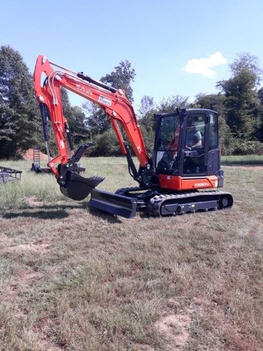 Kubota KX057-5 in Lawrenceburg pulling stumps and root balls