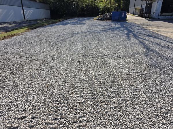 After: graded rock down the length of the new parking lot
