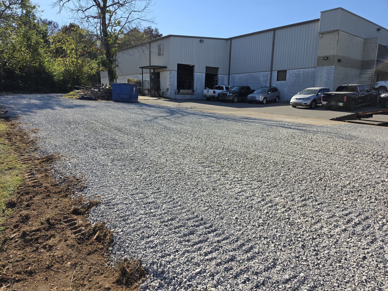 After: finished gravel parking lot behind the building, crusher run with #57 rock on top