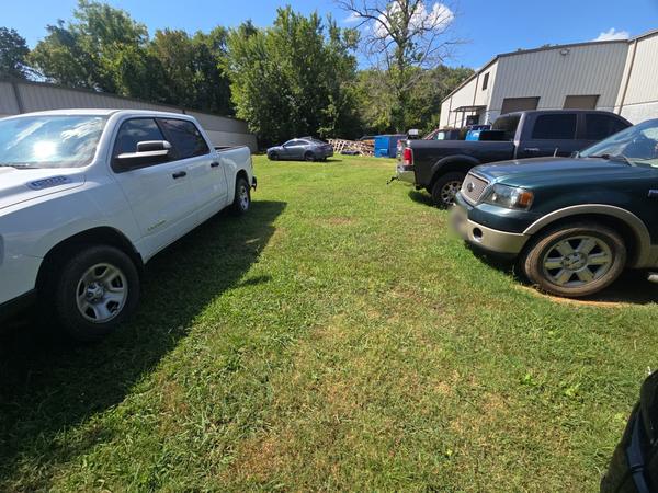 Before: trucks parked on the lawn next to the building