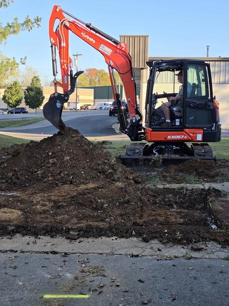 Kubota KX057-5 excavator stripping grass and topsoil for the parking lot