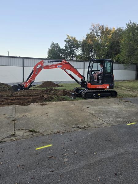 Kubota KX057-5 excavator reaching into the topsoil strip